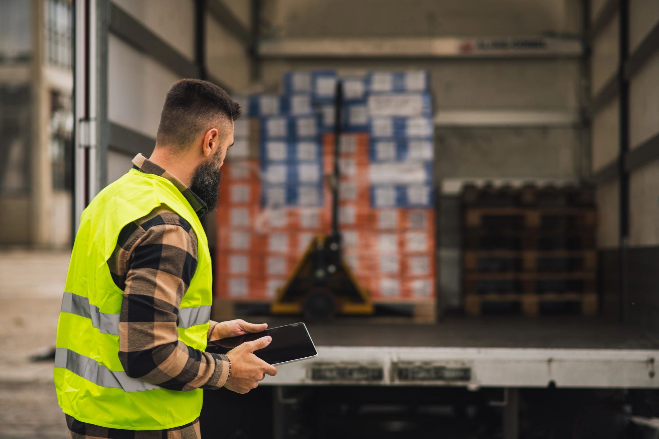 Logistics technician reviewing delivery documents on tablet